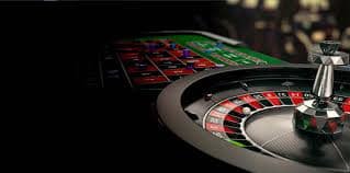 Live dealer roulette table with cards, chips, and professional croupier at multi-camera setup